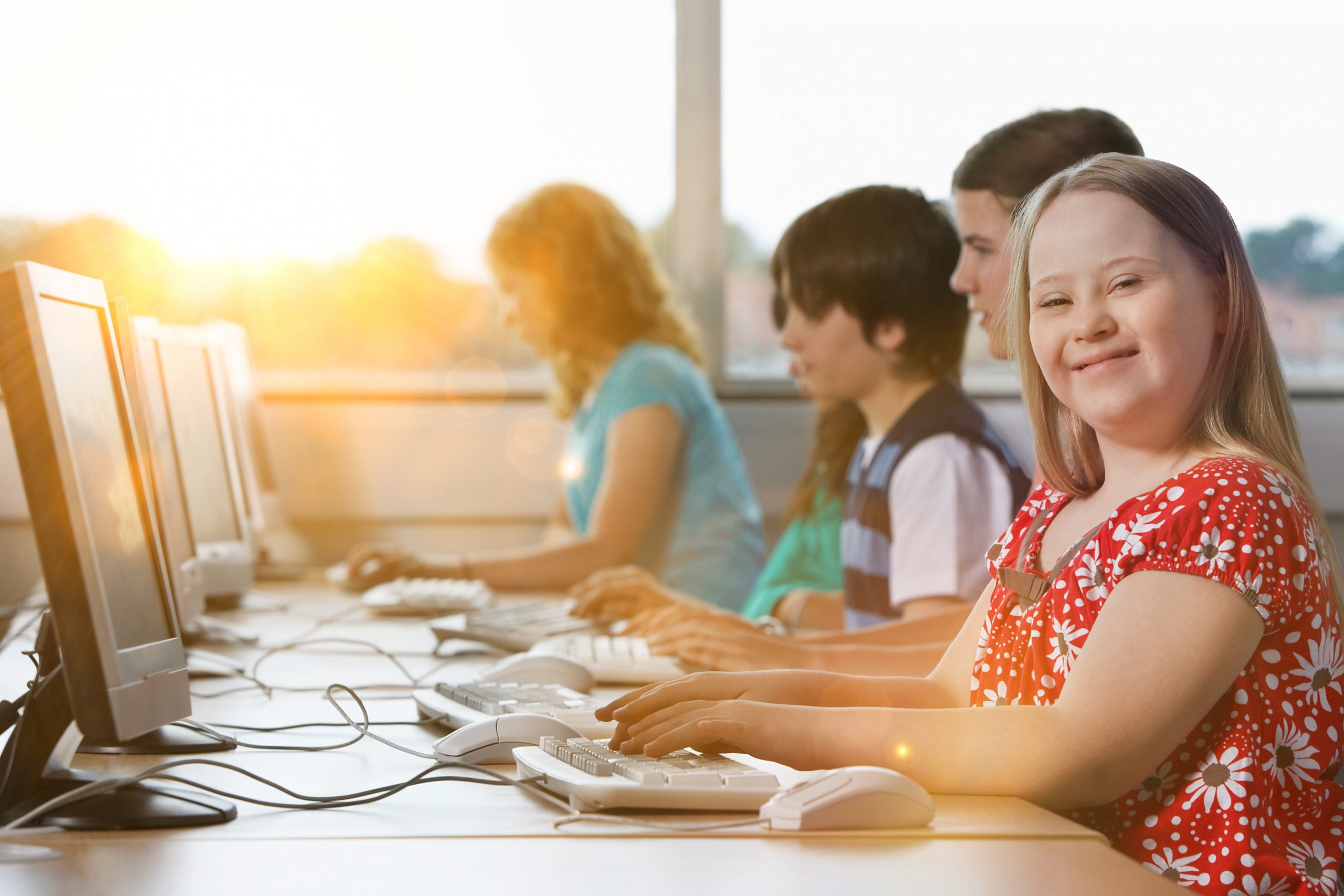Girl,with,down,syndrome,using,computer,at,school