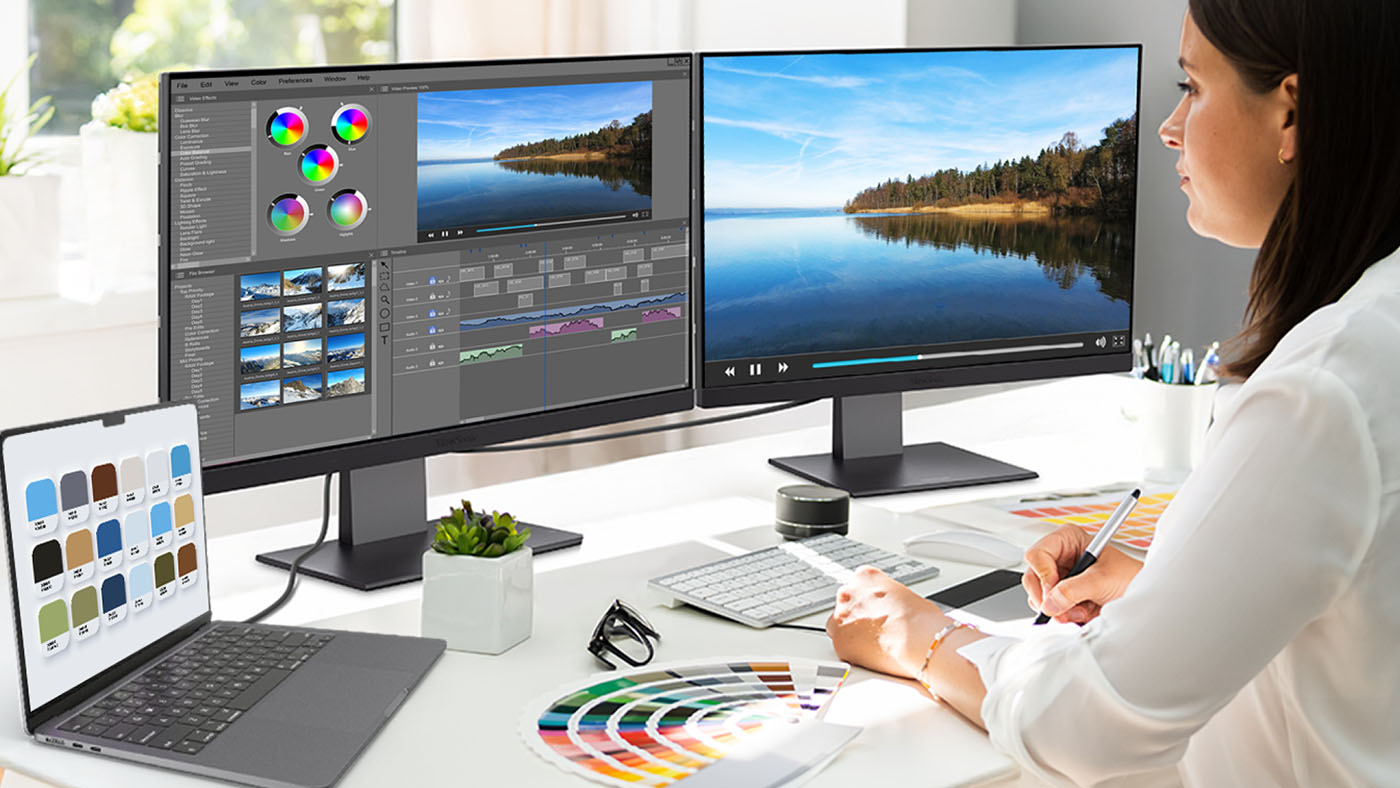 Photographer editing photos on a MacBook Air daisy-chained to two ViewSonic monitors.