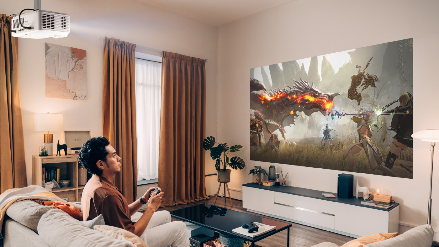 Gamer enjoying video game in living room with ViewSonic projector.