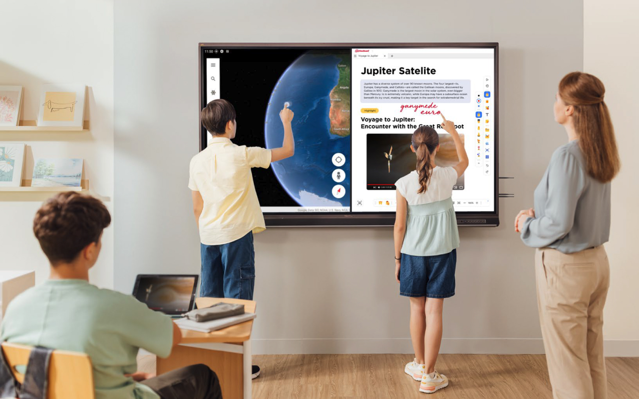 Students in class writing on ViewBoard interactive whiteboard while teacher oversees.