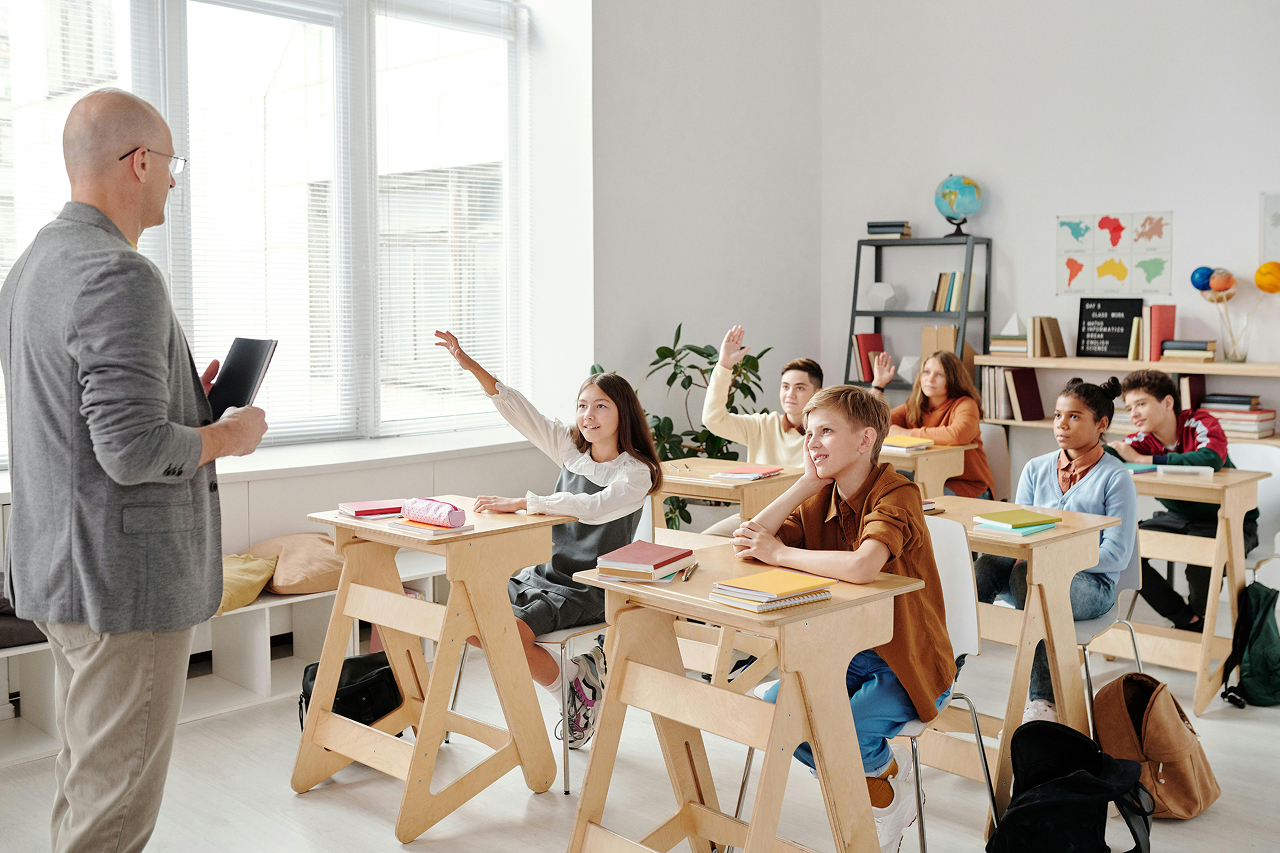 Teacher interacting with students in classroom.