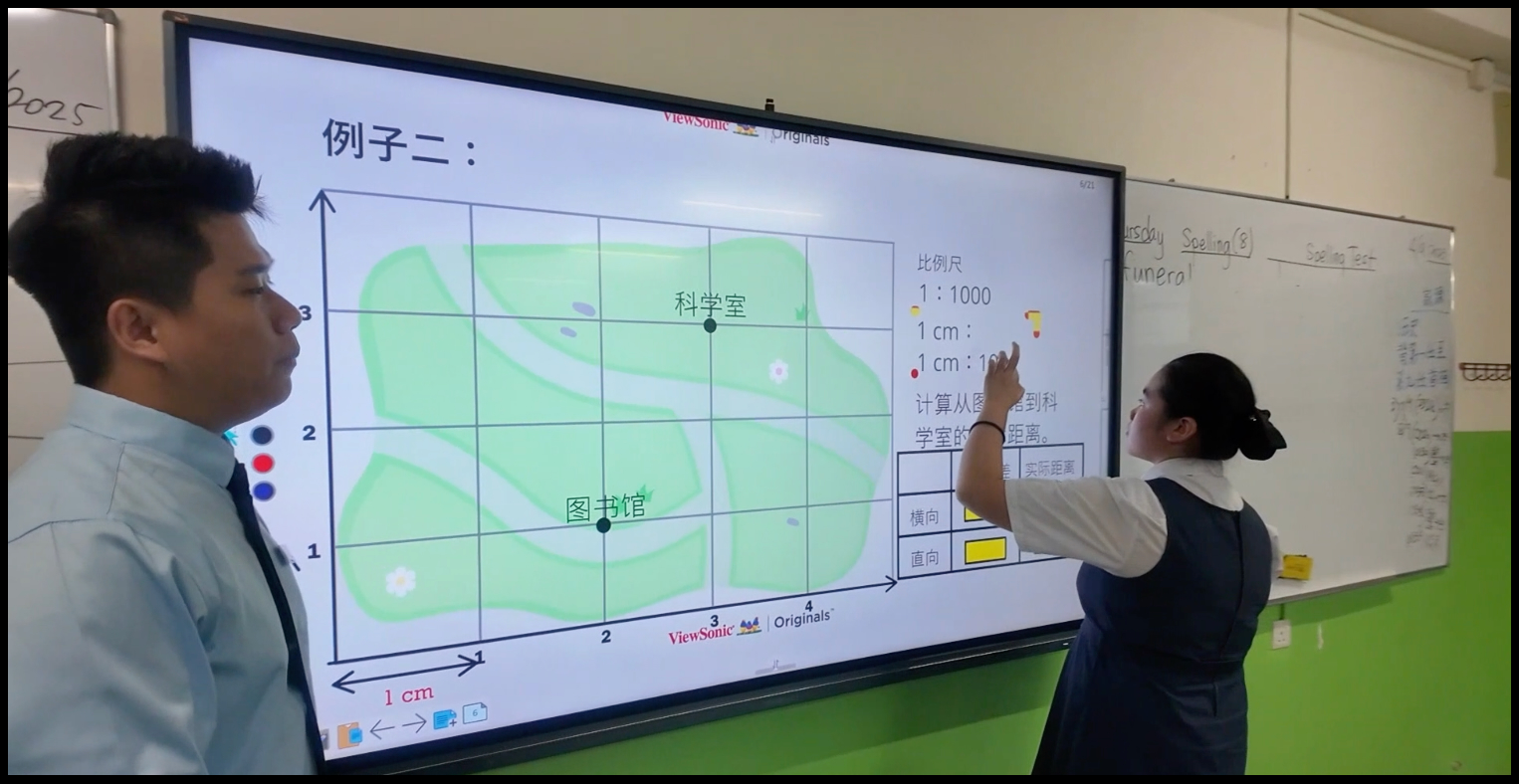 Teacher and student using interactive display.