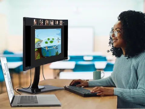 someone working on a curved monitor connected to a laptop