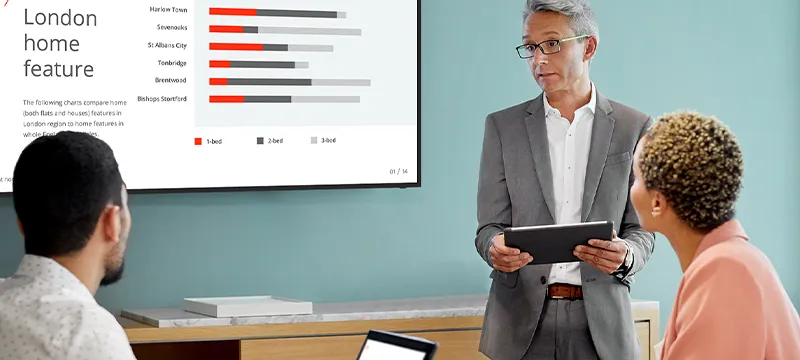a man giving a presentation on a digital display