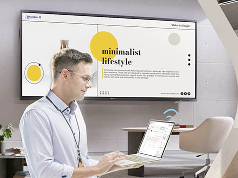 a man wirelessly sending content to a viewboard display from a laptop