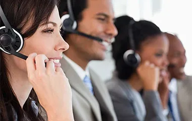 a line of support representatives wearing headsets