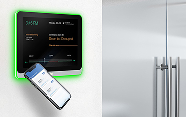 Employees at a conference table using a ViewBoard to meet with remote employees 