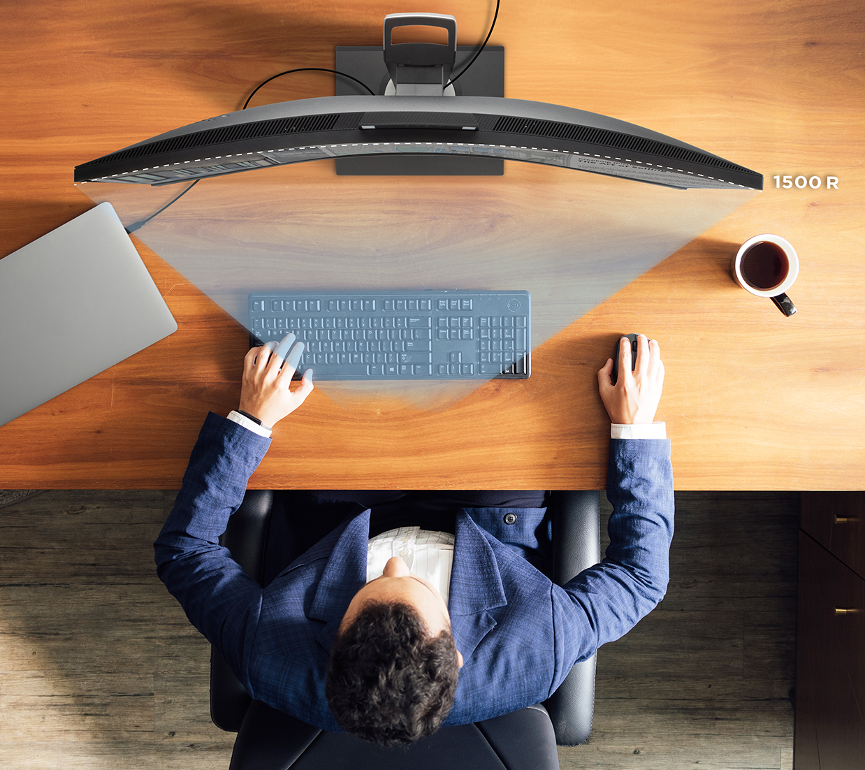 Birds eye view of man sitting at desk using an ultrawide monitor