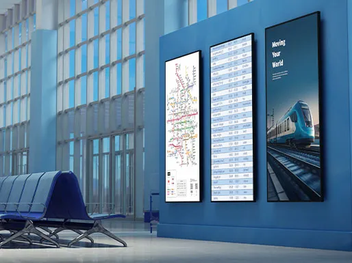 Three CDE31 displays in portrait mode hanging on a wall in a transportation hub