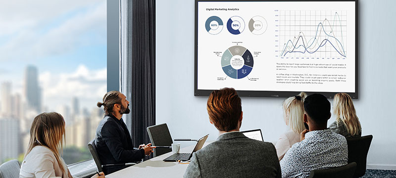 a businesswoman giving a presentation using a viewboard display in a conference room.