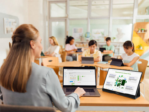 Teacher teaching a classroom from a podium using the ViewSonic ID2456-4K
