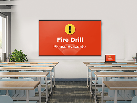 In a classroom, a ViewBoard at the front of a classroom broadcasting a Fire Drill
