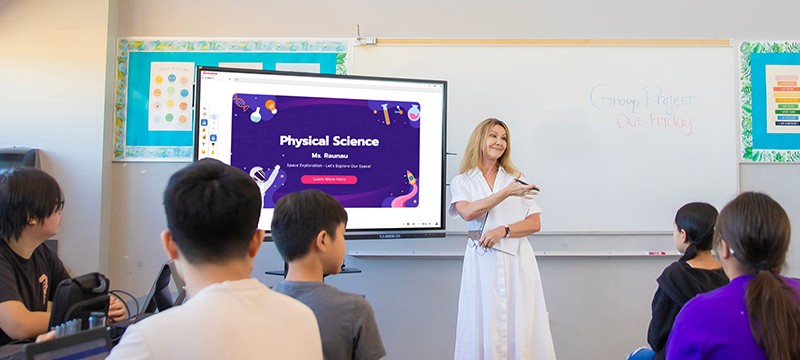 Teacher using a ViewBoard to help instruct a class of junior high or high school students