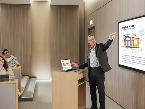 Instructor casting from his laptop on a podium and referring to content on a ViewBoard display