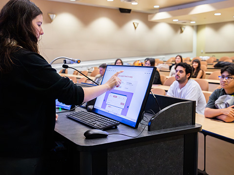 Instructor using a ID2456-4K interactive display to cast content to a classroom