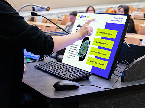 Male instructor using a myPodium interactive pen display to cast teaching content to his students