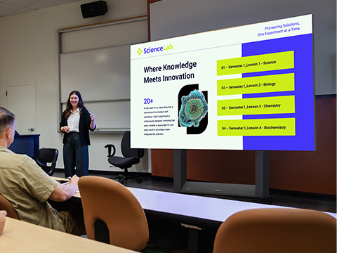 Large common area or student union in a high school or college with a dvLED placed on a high wall displaying school specific content