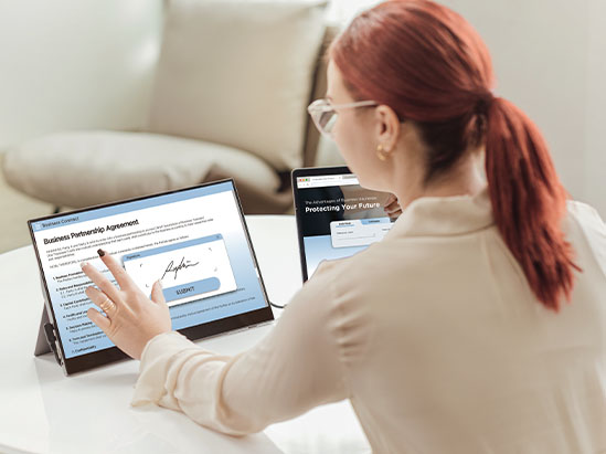 a woman using a portable touch display connected to her laptop
