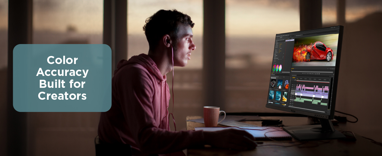 Young man editing video using a ViewSonic content creation monitor