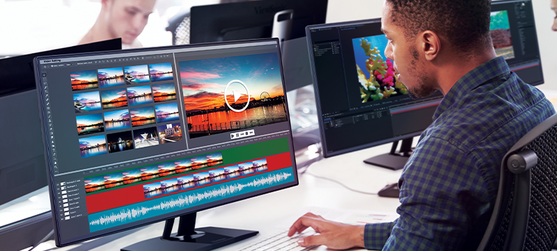 students raising their hands with a monitor in the foreground