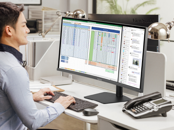 a man using photo editing software on an ultrtrawide display