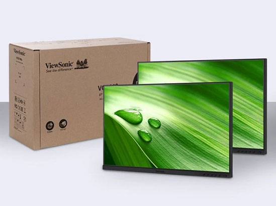 two monitors without stands next to a cardboard box