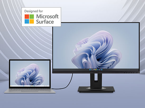 a microsoft surface laptop plugged in to a monitor