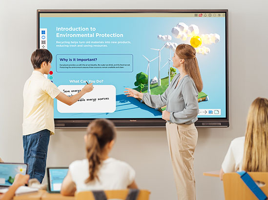 a teacher stands in front of a classroom motioning at a viewboard display