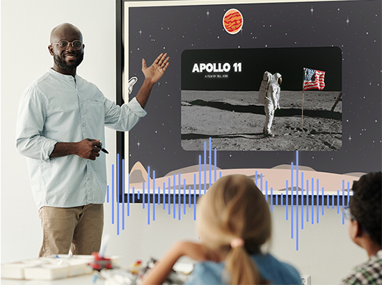 a teacher standing in front of a classroom motioning to a presentation on the viewboard display