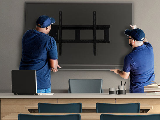installers hanging a display on a wall.