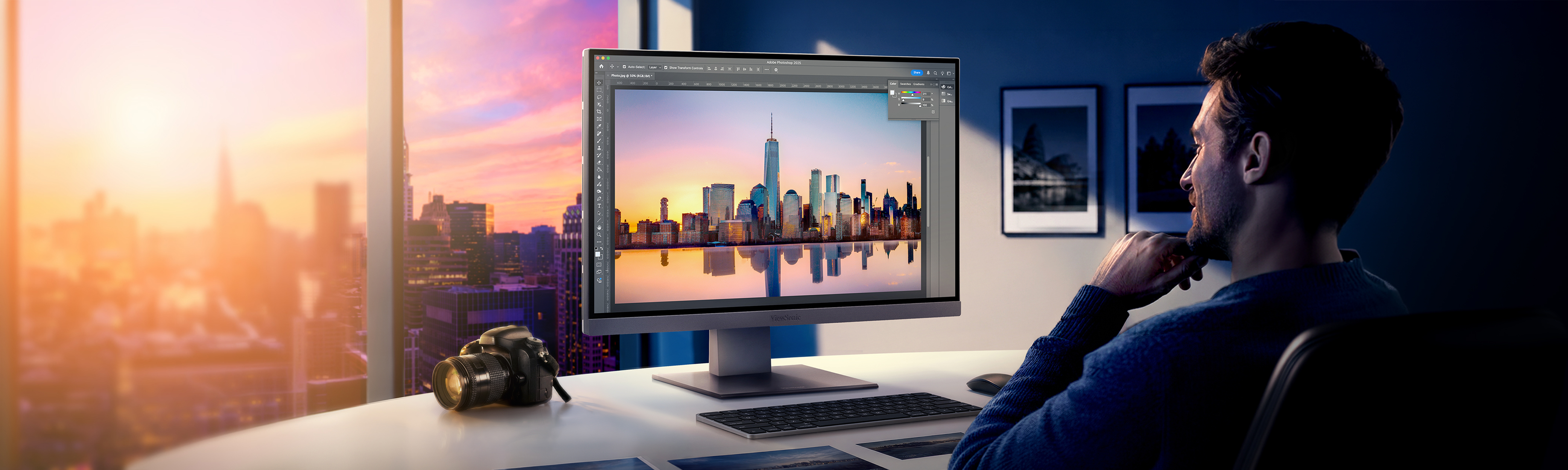 a man uses graphic design software on an ultrawide monitor