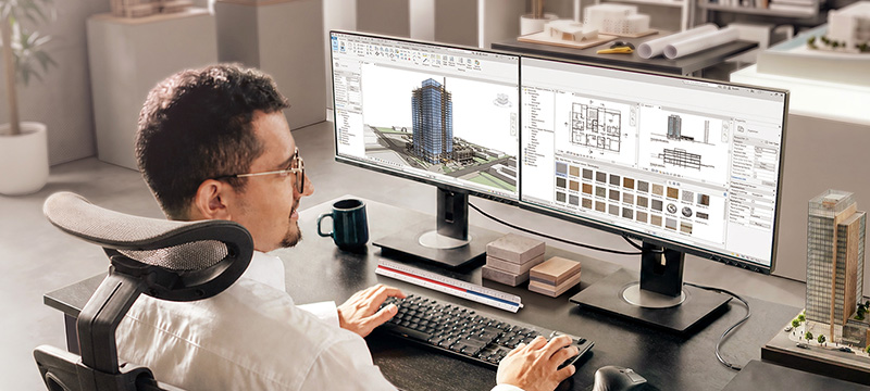 Architect or industrial designer working in an ergonomic home office setup featuring a ViewSonic business monitor connected to a laptop with a single USB-C cable