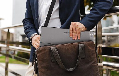 Man placing ViewSonic portable monitor into laptop bag