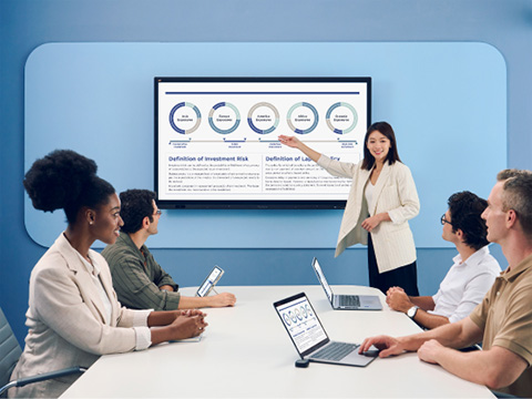 Woman conducting a meeting while referring to a graph on a ViewBoard