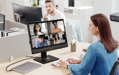 Employees in office video conferencing with remote workers using ViewSonic monitors