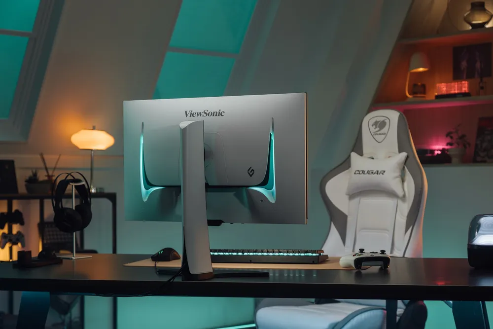 a gaming monitor at a desk with a gaming chair