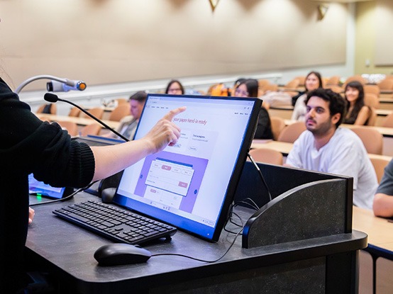 a teacher using a podium solution in front of a lecture hall