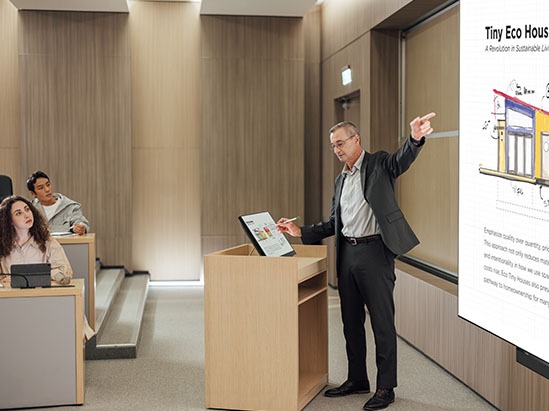 a male instructor teaching using a digital podium