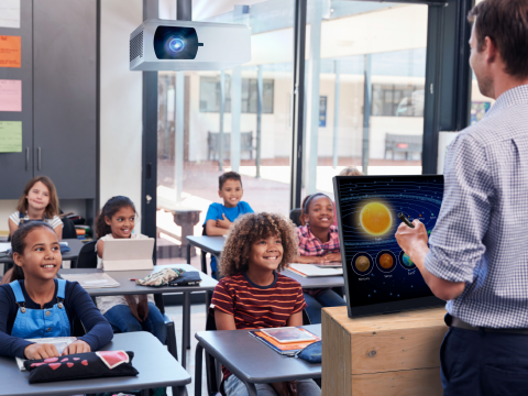 teacher using a ViewSonic ID2456 display and projector to instruct a room full of students