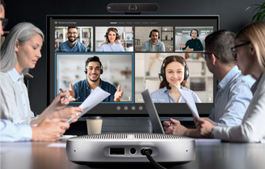 Employees at a conference table using a ViewBoard to meet with remote employees 