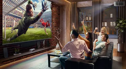 a family on a couch watching a projected video