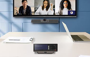 Conference room with large display showing remote workers in a meeting