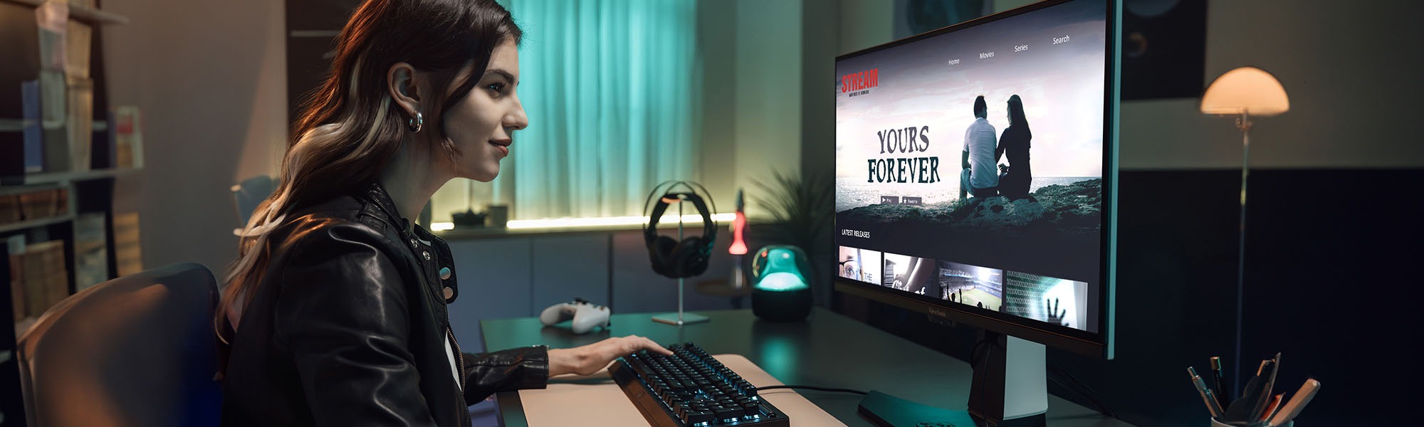 woman sitting at desk using a ViewSonic monitor to watch a show