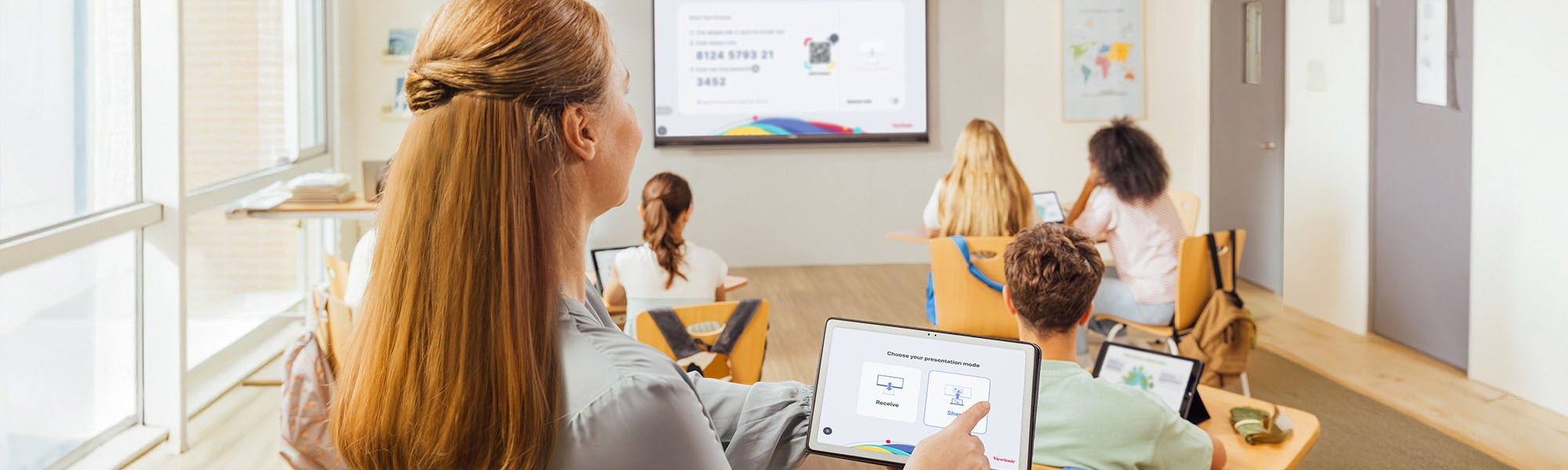 Student using a ViewBoard to explain aerodynamics to other students as teacher looks on