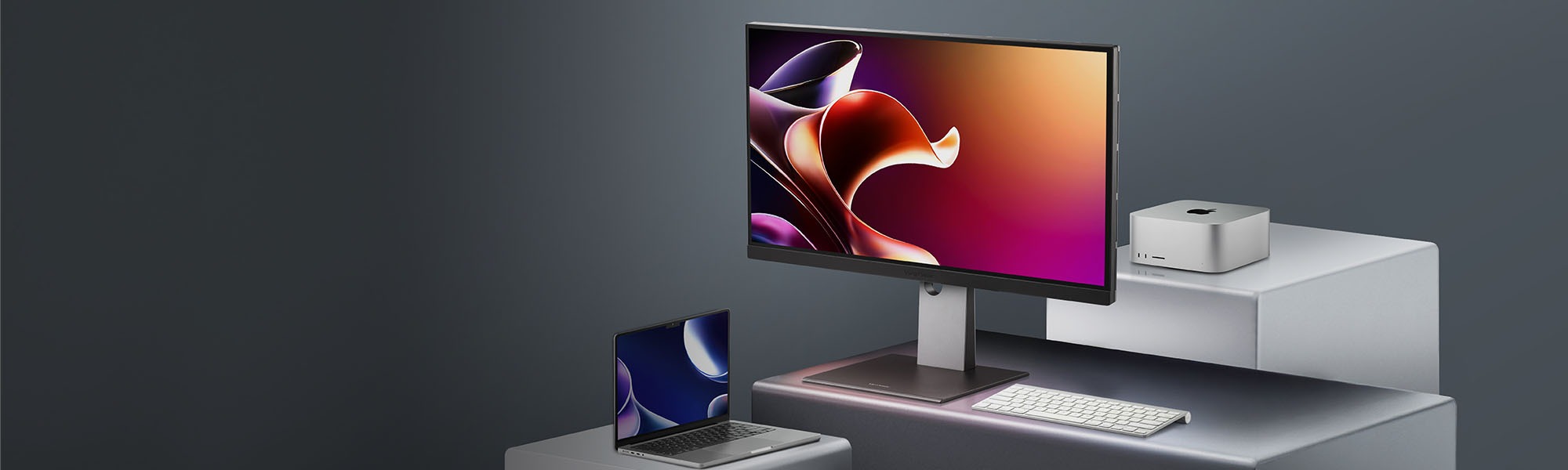 a woman uses graphic design software on two monitors