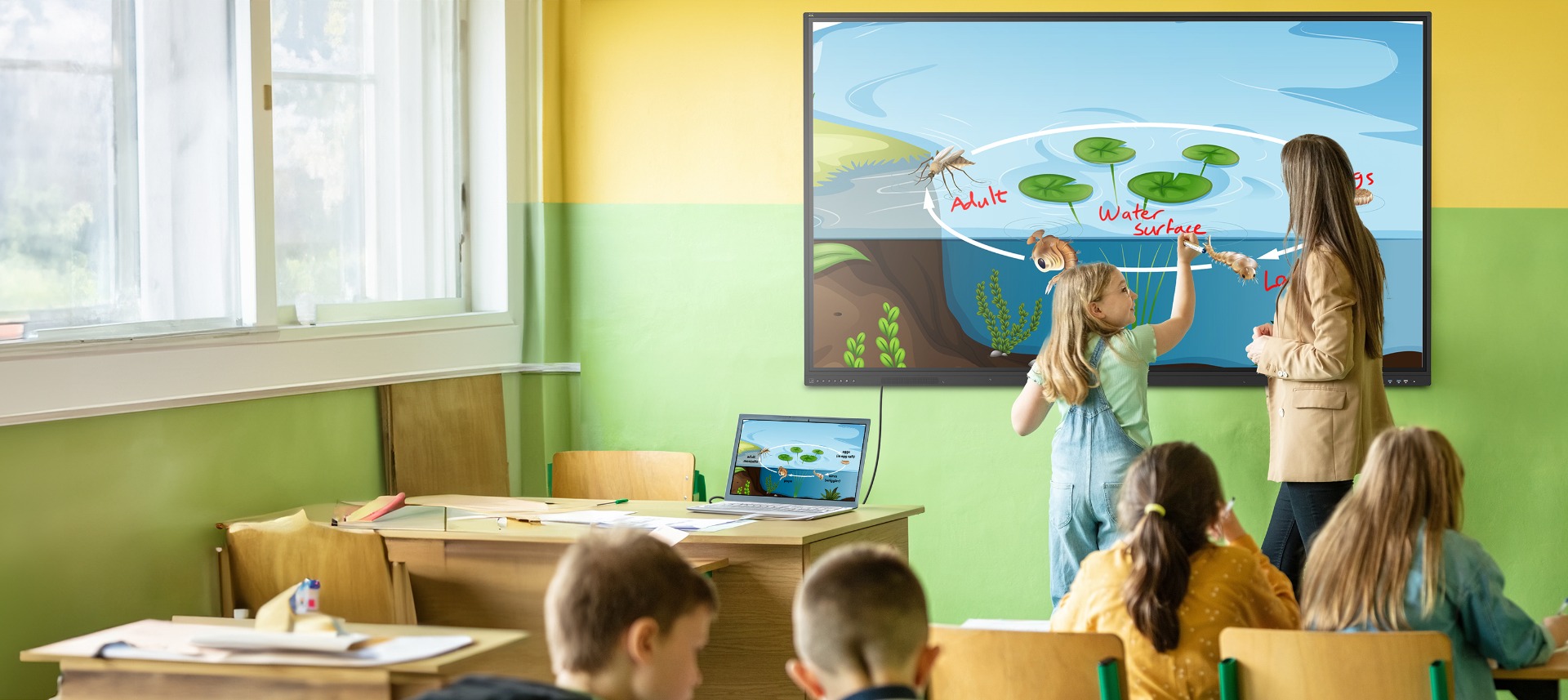 a crowd of people walking past a large projected image