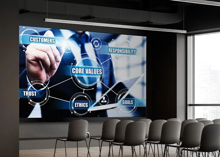 large conference room with large format display showing a presentation