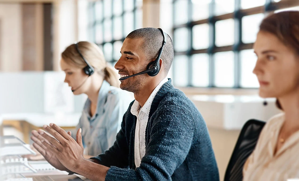 Tech support professionals communicating via headset.