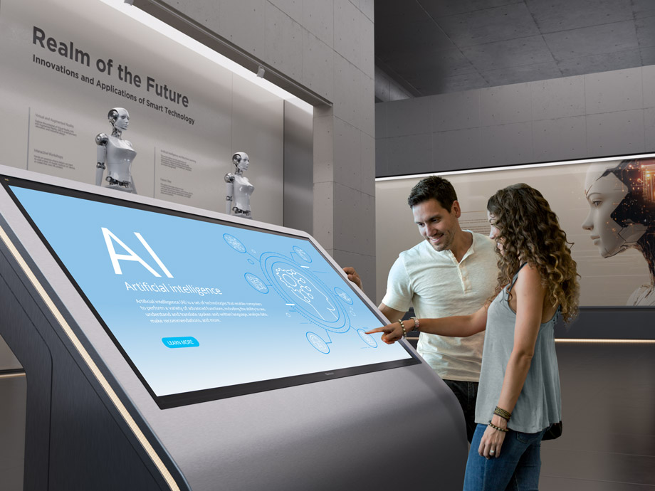 Visitors interacting with a touch-enabled exhibition display.