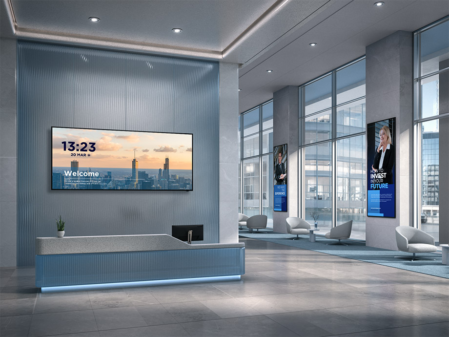 Employees viewing company updates on a big screen.